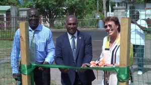 Premier of Nevis and Minister of Education Hon. Vance Amory cuts the ribbon to the new shade house donated by the Government and people of New Zealand with (left) Augustine Merchant, Coordinator of the Inter-American Institute for Cooperation on Agriculture in St. Kitts and Nevis and (right) New Zealand’s High Commissioner to St. Kitts and Nevis Her Excellency Jan Henderson
