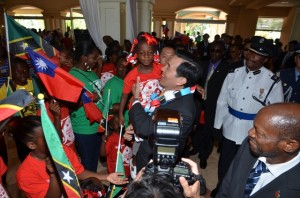 President of the Republic of China (Taiwan), His Excellency Dr. Ma Ying-jeou holds a child at the St. Kitts Marriott Resort. Right is St. Kitts and Nevis' Prime Minister the Rt. Hon. Dr. Denzil L. Douglas.