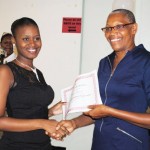Minister of Health the Hon Marcella Liburd (right) presents a certificate to the programme’s valedictorian Ms Selena Garnett. 