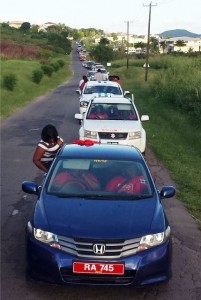 The motorcade traverses the countryside on its way to Abbott’s Housing Development.