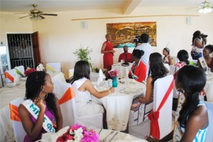 : The Hon Marcella Liburd (standing in the background, left) addresses the contestants and their chaperons