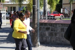 Senior and Junior Ministers of Health on Nevis Hon. Mark Brantley and Hon. Hazel Brandy-Williams conversing during the march through Charlestown in observance of World AIDS Day 2013