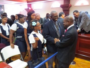 Lecturer at the Clarence Fitzroy Bryant College (CFBC) and former Minister in the PAM Administration, Mr. Hugh Heyliger congratulates St. Kitts and Nevis’ Prime Minister and Minister of Finance, the Right Hon. Dr. Denzil L. Douglas (right) on the presentation of the 2014 Budget while students of the Economics Class look on.
