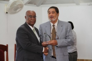 Leader of the Opposition Hon. Joseph Parry (l) receiving a plaque from Deputy Governor General His Honour Eustace John from the Nevis Island Assembly as one of the longest serving parliamentarian at a special sitting of the Assembly on December 10, 2013 at the at its Chambers in Hamilton House 