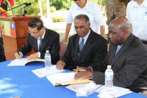 Documents signing by (extreme left) Republic of China/Taiwan’s Resident Ambassador to the Federation His Excellency Miguel Li-Jey Tsao and (extreme right) Minister of Agriculture on Nevis Hon. Alexis Jeffers while Premier of Nevis Hon. Vance Amory looks on, on December 06, 2013 