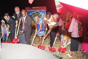  Turning the sod to break ground: From left, a child from the community, Ambassador Tsao, Governor General His Excellency Sir Edmund Lawrence, Prime Minister, the Rt Hon Dr Denzil Douglas, Minister the Hon Marcella Liburd, members of the New Road community Mr Sherwin Whyte, Mrs Ingrid Richards, and a community members who is partly hidden.