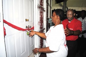 Comrade Amethyst Prentice of Upper Prickly Pear Alley preparing to cut the ribbon. Behind her is Prime Minister, the Rt Hon Dr Denzil Douglas