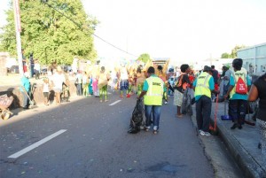 Bringing up the rear: After all the troupes would have streamed down, the unregistered SWMC Troupe falls in line, not to play mas, but to clean the streets. 