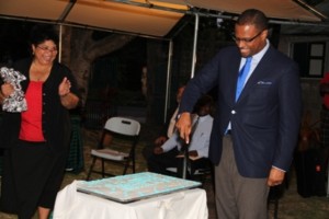 Acting Premier of Nevis Hon. Mark Brantley cuts a birthday cake at the Happy Birthday Alexander Hamilton ceremony on the grounds of the Alexander Hamilton Museum on January 10, 2014 while Mrs. Evelyn Henville Executive Director of the Nevis Historical and Conservation Society looks on 