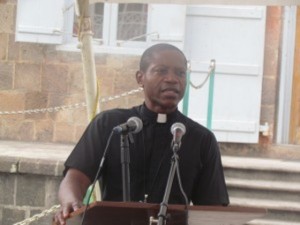Chairman of the NCC, Father Alric Francis during prayer service at the War Memorial Square in Charlestown.