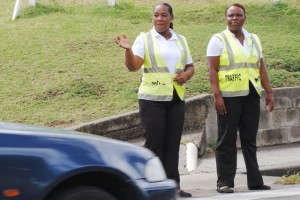 PEP Traffic Wardens Ms Odessa Lewis (left) and Ms Myrtle Barzey at work on the busy Cayon Street. 