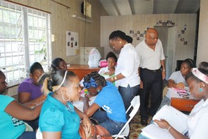 Colours of Success: Cosmetology trainees in Nevis during a colouring session. Looking on are Facilitator, Ms Krista Chapman, and PEP Training Coordinator for Nevis Mr Hensley Daniel.