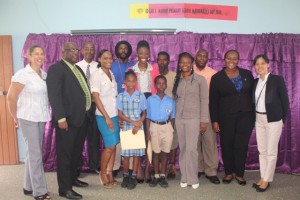 Ms. Sonia Boddie flanked by scholarship recipients and their parents and representatives of organizations who would have assisted her. Left to right, Mrs. Sarah Percival British Honorary Consul, Dr.the Hon.Timothy Harris,Mr. Stanley Knight, Education Officer Middle : Ms. Boddie, awardees and parents. Right to left: Ms. Vera Lai, 2nd Secretary in the Embassy of the Republic of China on Taiwan, Ms. Chereca Weaver, Senior Youth Officer, Mr. Kevin Edwards, Corporate Communications and Marketing Manager at Lime
