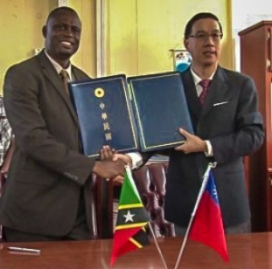 Ambassador Tsao (left) and Minister Carty after the signing of an Agricultural Technical Cooperation Agreement MOU, December 10, 2013