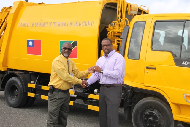 Nevis Health Minister hands over keys for waste disposal truck to Nevis Solid Waste Management Authority