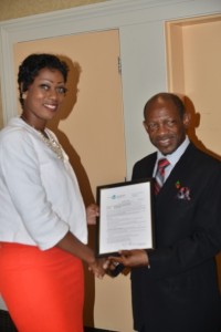 St. Kitts and Nevis’ Prime Minister the Right Hon. Dr. Denzil L. Douglas (right) presents certificate to Ms. Monique Lescott of St. Kitts to study medicine. 
