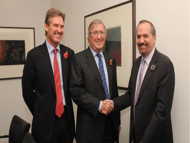 CONGRATULATIONS : Chairman of Cable and Wireless Communications (CWC), Sir Richard Lapthorne (centre) congratulates Chairman and CEO of Columbus International Inc. Brendan Paddick following the announcement of the proposed merger between CWC and Columbus in London today. Looking on is Phil Bentley, CEO of CWC.