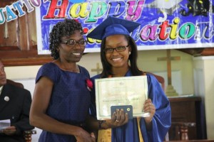 Valedictorian of the 2014 Graduating Class of the Gingerland Secondary School Cordiesere Walters receives her certificate from Patron, Jennifer Liburd, at the 41st Annual Graduation Ceremony of the Gingerland Secondary School at the Gingerland Methodist Church on November 27, 2014