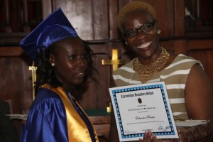 Charlestown Secondary School’s Caribbean Certificate of Secondary Level Competence (CCSLC) Valedictorian Ochanta Parris receives her Certificate of Graduation from Mrs. Marva Roberts 
