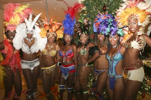Models in Sugar Mas costumes welcome the pokers players to St. Kitts