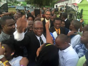 Dr Harris greeted by hundreds of supporters outside Government House