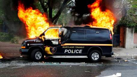 Baltimore erupts in riots after funeral of black man