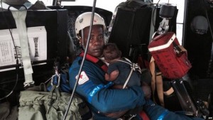 Baby Yudier Moreno was held by a rescuer on the flight back to Quibdo 