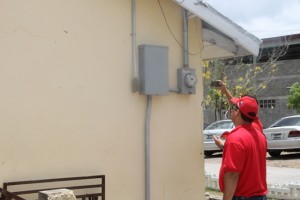 Members of the Venezuelan delegation assessing the electricity supply at the Charlestown Secondary School on June 04, 2015