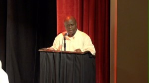 Permanent Secretary in the Premiers Ministry Wakely Daniel giving remarks at the 6th annual joint School Libraries and Department of Education’s Warner’s One Stop Family Book Feud on July 11, 2015, at the Nevis Performing Arts Center 