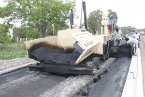 Nevis Public Works Department workers applying the first layer of asphalt concrete on Hanley’s Road during the Hanley’s Road Rehabilitation Project on October 09, 2015