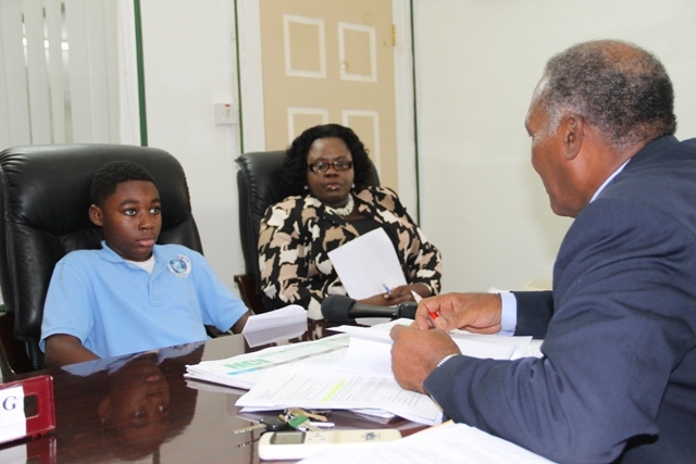 Nevis International Secondary School student presents water desalination proposal to Premier Amory