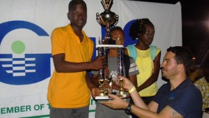 Students from the Elizabeth Pemberton Primary School accepting their winning trophy for Division B from a Gulf Insurance Representative during the presentation ceremony at the end of the 24th Gulf Insurance Athletics Championships at Elquemedo T. Willet Park on March 30, 2016 