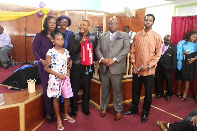 PEP participants living with disabilities present handmade craft items to Bishop Hepburn