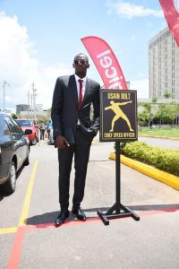 Usain Bolt, Digicel’s Chief Speed Officer (CSO) checks out his designated parking slot on his first day at work at the Digicel regional HQ