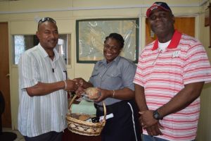 Officer on Duty at the Sandy Point Police station surpised by Commissioner Queeley bearing a Christmas Treat.