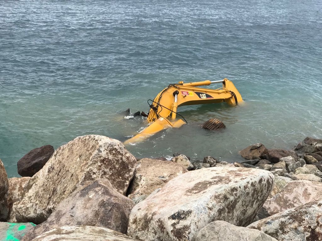 Driver at second cruise ship pier site escapes  death when excavator topples into the sea