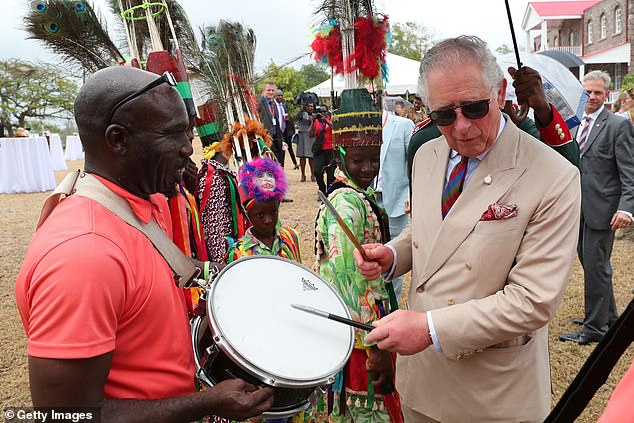 Dancing girl! Camilla looks on as adorable little girl greets her with a twirl during her and Charles’ one day tour of St Kitts and Nevis on their whirlwind Caribbean tour