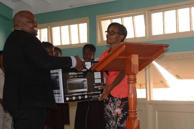 Nevis Association of South Florida hands over Microwaves to Gingerland High School