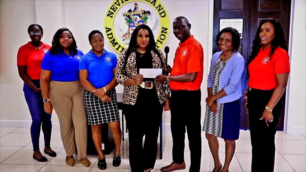 Ministry of Tourism Nevis Celebrates Community Support Through Cheque Handover to Mrs. June Queeley
